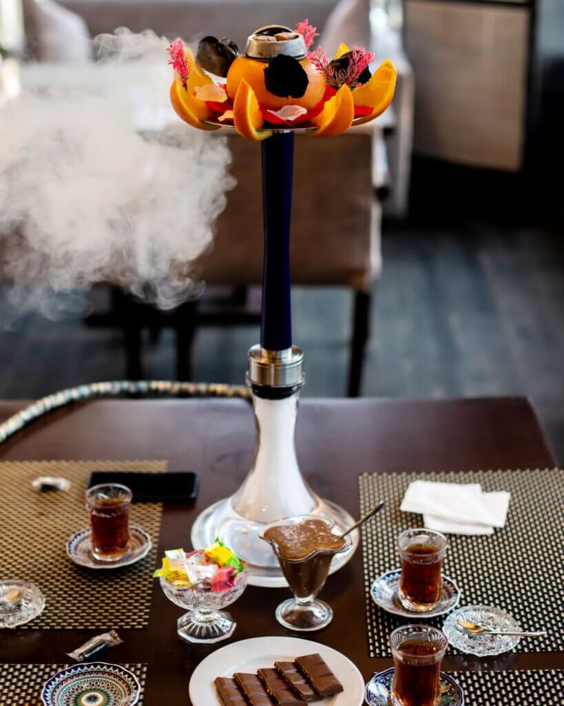 hookah-decorated-with-orange-flowers-tea-with-sweets-table